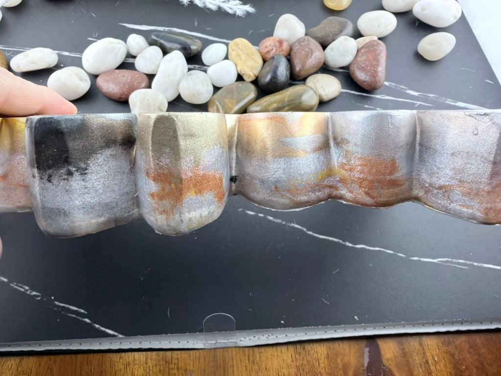 Blessed resin sign standing against a grey tile backsplash