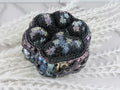 Detail of the iridescent rhinestones on the paw print lid