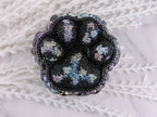 Paw print resin trinket box with rhinestone lid beside the gem-lined base