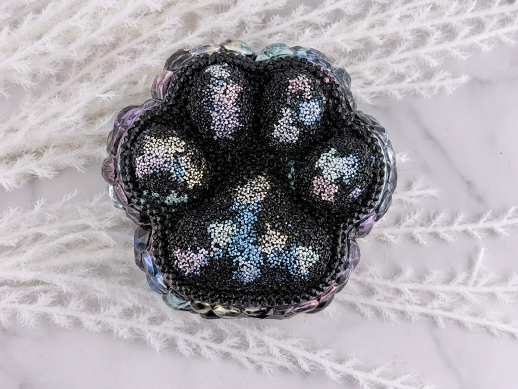 Paw print resin trinket box with rhinestone lid beside the gem-lined base